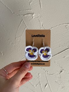 Crochet Pansies Earrings 💜 These are the cutest Spring/Summer accessory!  Each set of earrings is made with 100% Cotton Yarn and Sterling Silver Jump Rings/ Fish Hooks with silicone backs. Handmade Playful White Jewelry, Playful Handmade White Jewelry, Playful White Handmade Jewelry, Cute Adjustable Earrings For Beach, Cute Adjustable Earrings For The Beach, Playful Handmade Adjustable Earrings, Trendy Handmade White Flower Earrings, Trendy White Handmade Flower Earrings, Trendy Handmade White Earrings