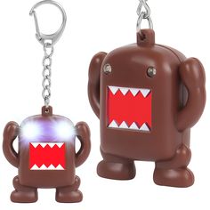 a brown and red monster shaped keychain with a light up face on it