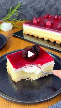 a piece of cake with raspberry toppings on it is being held by a person