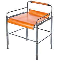 an orange chair sitting on top of a metal frame