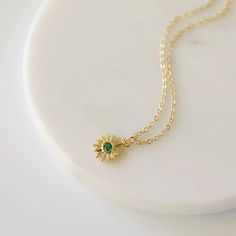 "Beautiful and lovely tiny gold sun pendant necklace. Made of tiny emerald green cubic stone gold sun charm with a skinny gold plated brass chain. Soft and simple. Great for gift, everyday or special occasion. Your item will ship in a gift box. Please feel free to contact me if you have any question. ♥ Length 14\" - 20\" chain ♥ Sun charm 1/2\" ♥ Gold plated over brass/ Emerald Green Cubic Zirconia ♥ See more Rudiana Accessories Rudiana.etsy.com" Dainty Clavicle Chain Necklace For May Birthstone, Dainty Gold Emerald Birthstone Necklace, Dainty Emerald Gold Necklace, Dainty Gold Emerald Necklace With Delicate Chain, Dainty Emerald Necklace For May Birthstone, Delicate Gold Emerald Necklace As Gift, Dainty Gold Necklace With Emerald, Dainty Green Emerald Necklace As Gift, Gold Emerald Pendant Necklace For Everyday