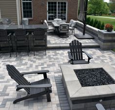 an outdoor patio with chairs and fire pit