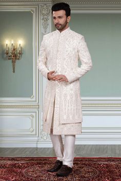 This men's sherwani, R14-S91, features a Double-layer design specifically crafted for grooms. The traditional thread embroidery and stone accents add an elegant touch to any wedding outfit. Experience the comfort and sophistication of this expertly crafted sherwani. Elegant Embroidered Sherwani For Groom, Reception Sherwani With Chikankari Embroidery, Elegant Embroidered Groom Sherwani, Chikankari Embroidery Sherwani For Reception, Groom's Transitional Sherwani With Chikankari Embroidery, Groom's Kurta With Intricate Embroidery In Traditional Drape, Groom's Traditional Wear With Chikankari Embroidery, Traditional Groom's Kurta With Intricate Embroidery, Traditional Kurta For Groom With Intricate Embroidery