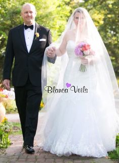 the bride and groom are walking down the path