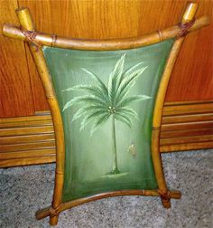 a painting of a palm tree on a green cushion