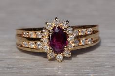 The Cardston: Ladies 14K Yellow Gold Ring set with Ruby and Diamond. The ring centers on a 0.75 carat oval ruby surrounded by a halo of diamonds. Two diamond set channels make up either side of the shank. The ring is currently a finger size 7.5 and is able to be resized for an additional charge upon request. Love this piece, but don't have the money to spend right now?  We offer FREE layaway on every item in our shop.  With just 20% down, take one full year (interest-free) to pay off your new je Ring Inspo, Ruby Engagement Ring, Gold Ring Sets, Knot Ring, Square Rings, Funky Jewelry, Diamond Set, Yellow Gold Ring, Book Decor