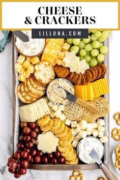 the cheese and crackers platter with grapes, pretzels, crackers, olives