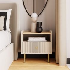 a white nightstand with a mirror on it next to a bed