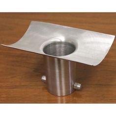 a metal object sitting on top of a wooden table