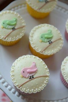 cupcakes decorated with fondant birds on a plate