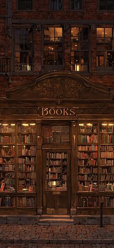 an old book store is lit up at night with books on the windows and doors