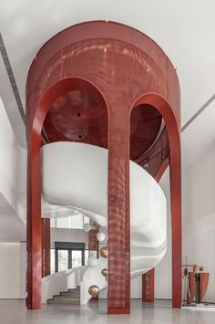 a large white and red structure in the middle of a room with stairs leading up to it