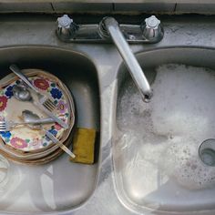 dirty dishes and utensils are sitting in the sink