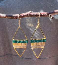 Handmade beaded Native American earrings. Emerald green and gold. Hung between 2 different sized gold colored triangles. Gold color ear wire hooks. Sparkly! Length  - 2.75 inches (with ear wire hook) Width  - 1 inch I am Dakota, Seneca and Navajo, so you are buying authentic Native American items. If you have any questions please feel free to ask!  :) Green Dangle Beaded Earrings With Gold Beads, Green Metal Beaded Earrings For Party, Green Metal Beaded Party Earrings, Gold Beaded Earrings With Ear Wire For Party, Adjustable Triangle Beaded Earrings, Green Metal Beaded Earrings With Round Beads, Green Beaded Earrings With Round Metal Beads, Geometric Beaded Gold Earrings, Gold Triangle Beaded Bohemian Earrings