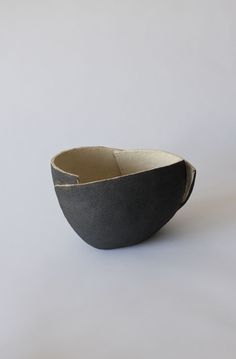 a black and white bowl sitting on top of a table