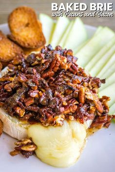 baked brie with pecans and bacon on a white plate next to apple slices