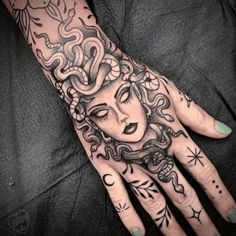 a woman's hand with tattoos on it