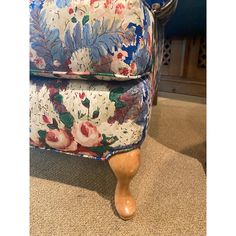 a blue and white chair sitting on top of a carpeted floor