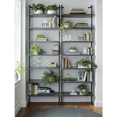 a bookshelf filled with lots of different types of plants on top of it