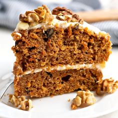 a slice of carrot cake on a plate with a fork