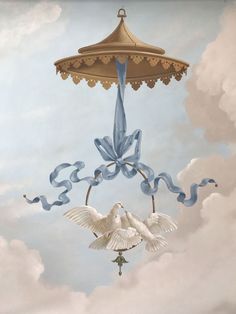 two white doves are flying in the sky under a blue and gold umbrella with ribbons on it