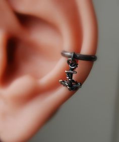 "Sailors Anchor Ear cuff - Nautical jewelry - Pierced - Non-pierced - Dark Anchor Earrings - Sterling Anchor Earrings - Captains gift - For your Pirate Sailor- Small sterling silver anchor in a conch cuff. You will love the detail in this and will be a special gift to your sailor.   I darken the sterling to look like iron but I can leave it shiny. Note that the model in the video is 30% larger than a normal man's ear.  The cuff in the video is a Large Sz 1/2\" ID Sizes available are 3/8\" (10mm) Dark Pirate, Pirate Earrings, Pirate Anchor, Conch Cuff, Captain Gifts, Pirate Jewelry, Anchor Jewelry, Anchor Earrings, Anchor Pendant