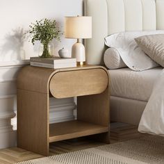 a bedroom with a bed, nightstand and lamp