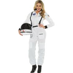 a woman in white is holding a helmet and posing for the camera with her hands on her hips