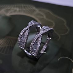 an image of two wedding rings on display