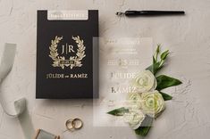 wedding stationery with flowers and rings next to it