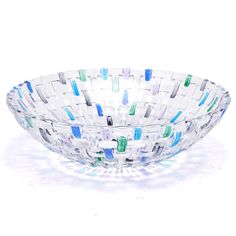 a glass bowl with blue, green and white designs