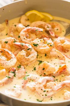 a pan filled with shrimp and sauce on top of a table