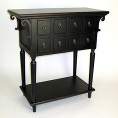 a small black table with drawers on it