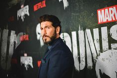 a man standing in front of a wall with the words'captain america 2'on it