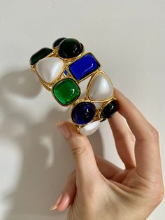 Giving serious Chanel vibes! These blue and green resin cuffs glow in the light! Set in luxe gold plate with matte pearl details. Absolutely stunning and chic to wear one on each arm! Perfect for your next holiday party. Contemporary - new condition.Internal diameter 2.5 inches x 2.25 inches. Price is for one cuff bracelet. Byzantine Jewelry, Pearl Cuff Bracelet, Pearl Cuff, Pearl Details, Woman Style, Gold Bracelet Cuff, Gold Cuffs, Next Holiday, Gold Pearl