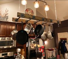 pots and pans are hanging from the ceiling