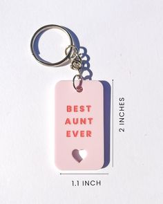 a pink keychain with the words best aunt ever printed on it and a heart