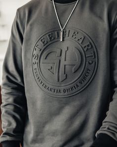 This SteelHeart Signature Embossed Sweatshirt with embossed SH emblem logo on front and lettering on the sleeve is unlike any other sweatshirt and makes a bold statement. High quality, top tier, breathable and anti-shrinkage fabric is what makes this sweatshirt so exquisite. Designed down to the very last detail like the different color collar and sleeve cuff, this custom piece will have you looking great and feeling even better. Snag this sweatshirt in one of the 3 versatile color ways and styl Event Merch, Embossed Sweatshirt, Sweatshirt Inspiration, Black Creators, Athleisure Lifestyle, Heart Clothing, Urban Island, Free T Shirt Design, Creative T Shirt Design