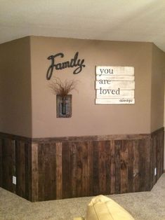 the family room is decorated with wood paneling and signs on the wall above it