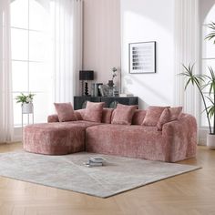 a living room filled with furniture and a rug on top of a hard wood floor