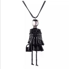 a black and white necklace with a ball on the end of it, hanging from a chain