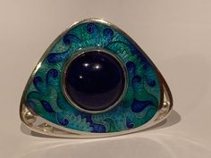 Handmade Cloisonne Enamel on Silver Ring with Natural Lapis Lazuli Stone Handmade by me and my 19 year old son in our beautiful Kansas City studio. See our work and follow us on Instagram please. Questions and comments are welcome. Get free shipping when you become our follower. Instagram: https://www.instagram.com/anaraandco/ Cloisonne is ancient art, that dates centuries back in history. Tiny silver wires were bent and twisted according the design. Then small sections were filled with colorful Unique Blue Jewelry For Ceremonial Occasion, Handmade Ceremonial Blue Jewelry, Unique Blue Ceremonial Jewelry, Formal Round Cabochon Enamel Ring, Artistic Handmade Ceremonial Jewelry, Ornate Ceremonial Enamel Jewelry, Vintage Cloisonne Jewelry, Cloisonne Enamel Jewelry Jan Van Diver Jewelry & Enamels, Luxury Cabochon Lapis Lazuli Rings