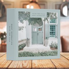 a book sitting on top of a wooden table in front of a window and door