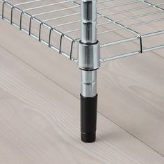 a close up of a metal rack on a wooden floor