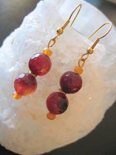 Lovely Drop earrings with TWO FACETED Ruby Glass Beads....Shaded glass handmade so there are slight variations in each glass bead...Small Yellow glass beads separate the Red ones giving length and separation... I have threaded them all onto Gold fittings.. Non-Allergenic.... Measure from base of Hook to end 3.5+Cms Elegant look ! Handmade Amber Round Bead Earrings, Handmade Amber Beaded Round Earrings, Handmade Amber Earrings With Round Beads, Handmade Agate Round Bead Earrings, Amber Czech Glass Drop Earrings, Dangling Glass Round Bead Earrings, Dangling Glass Beaded Earrings, Glass Earrings With Faceted Beads As A Gift, Glass Faceted Beads Earrings For Gift