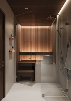 a modern bathroom with wood paneling and white tile flooring, along with a walk in shower