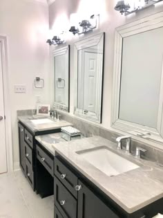 a large bathroom with double sinks and mirrors