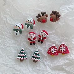 christmas decorations are arranged on a sheet of white paper with reindeers and snowmen