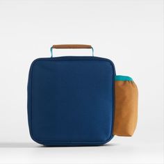 A fun and functional lunch box that's built to handle all the thrills and spills of the day. Combining colorblocks of navy and ocher with pops of aqua trim, our bag is constructed of food-safe and supremely durable polyester made from recycled water bottles. It's also lightweight and easy to clean, plus roomy enough to hold multiple storage containers. An insulated lining keeps meals just the way your kid likes them—hot, cold or somewhere in between. An outer pocket safely stows a napkin, utensi Blue Rectangular Lunch Box For Daily Use, Blue Rectangular Lunch Bag For Daily Use, Blue Functional Lunch Bag For Everyday Use, Functional Blue Lunch Bag For Everyday Use, Functional Blue Lunch Bag, Functional Rectangular Lunch Bag For Back To School, Blue Rectangular Lunch Box For Outdoor Activities, Back To School Rectangular Lunch Box For Outdoor Activities, Rectangular Lunch Box For Back To School