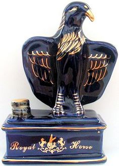 an eagle figurine sitting on top of a blue box with gold trimmings